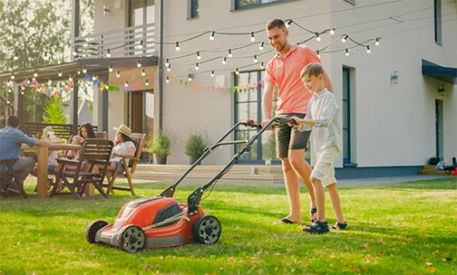 father and son lawnmowing 