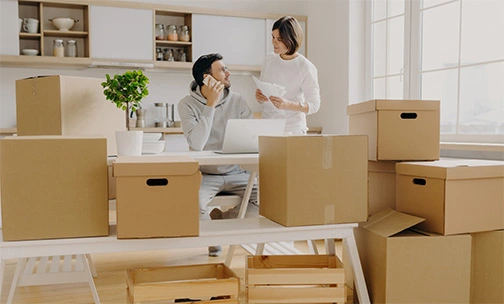 couple with boxes in office space