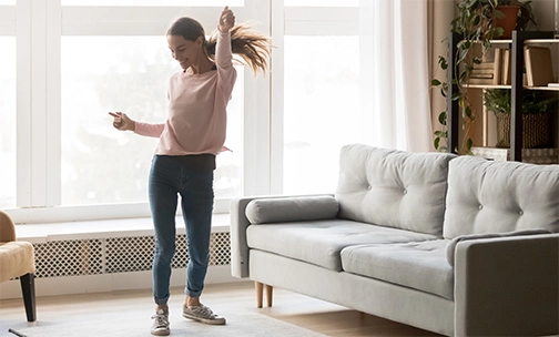 lady exercising in front of living room couch