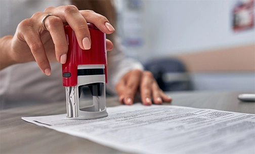 two people standing in front of their first house