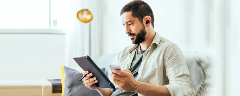 man interacting with tablet