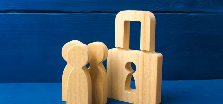 wooden figures with padlock