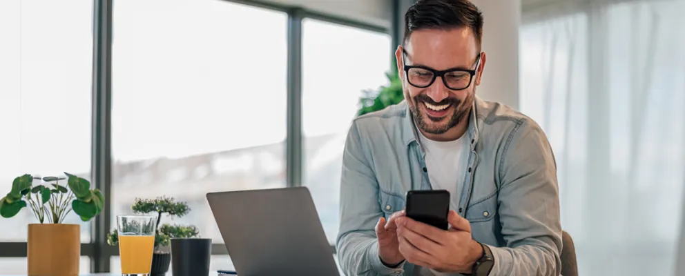 man looking at the phone and smiling