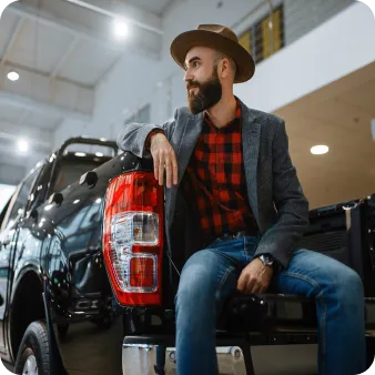 A man sitting on a car