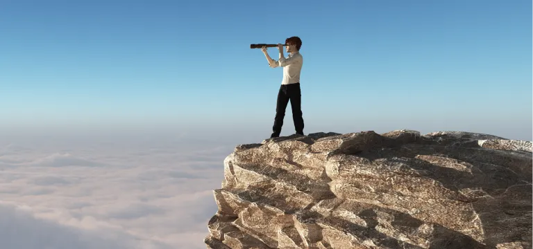 Man viewing scenery from a high mountain cliff