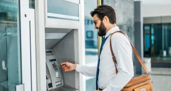 a person accessing the cash in penfed atm