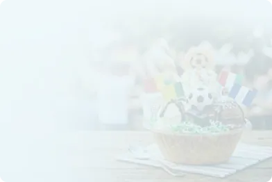 A festive soccer watch party setup featuring themed bowls resembling classic black and white soccer balls, filled with colorful ice cream and topped with small country flag.