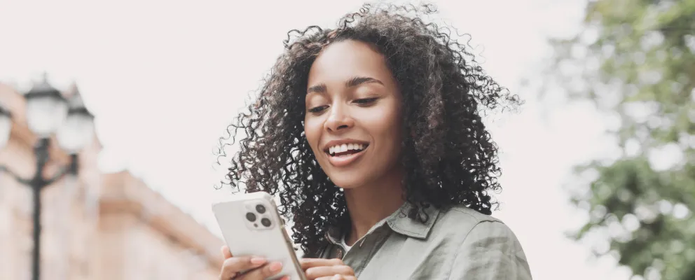 A lady looking at her iPhone