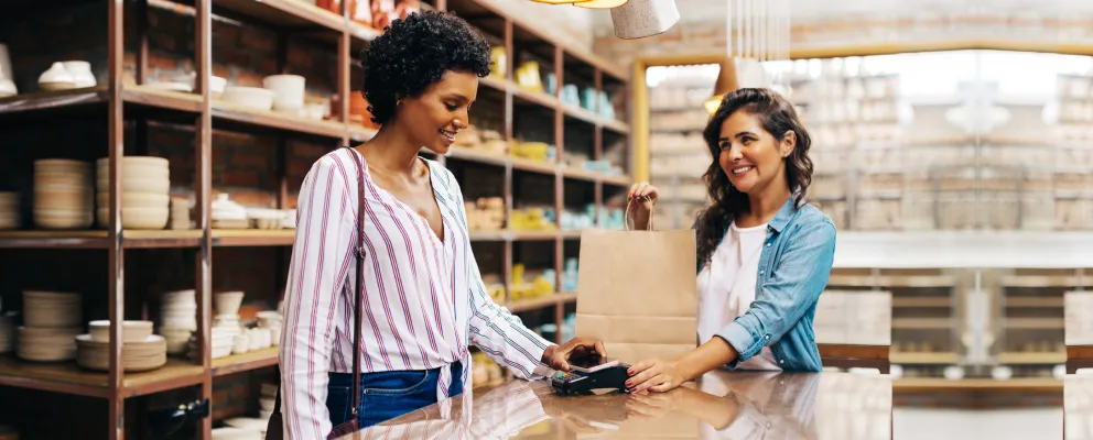 A lady paying online at checkout counter