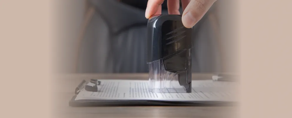 a person stamping the paper