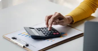 calculator and glass jar labeled "RETIREMENT" filled with coins