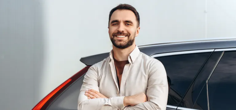 a man standing near his dream car