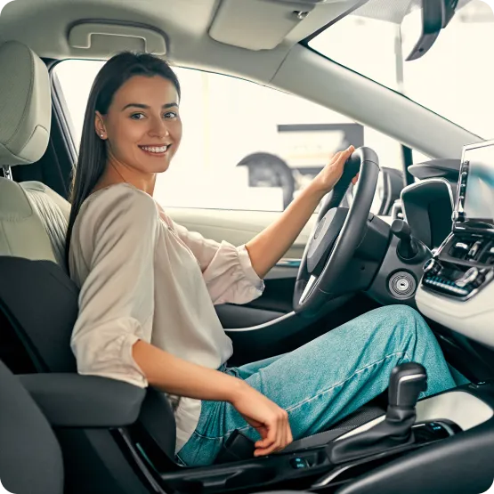 a girl sitting inside her new car