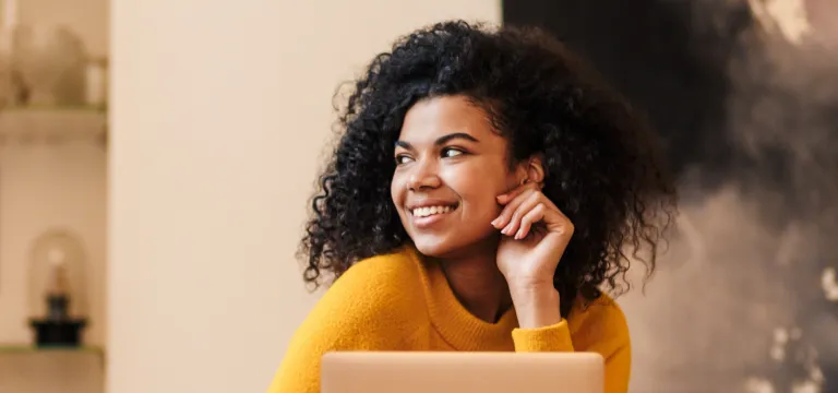 Women working on laptop and smiling