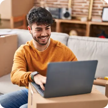 Young man working on the laptop and smiling