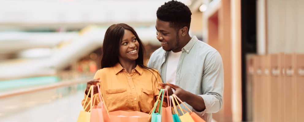 Couple holding bag and smiling