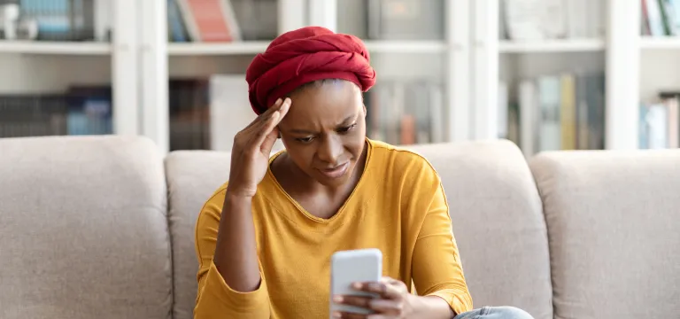 Women looking at her mobile viewing her transactions on her card
