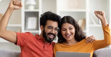 women viewing her mobile phone while holding a credit card