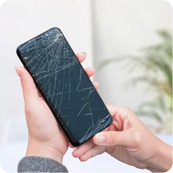 a person holding a broken phone in hand