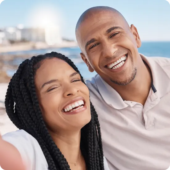 Happy couple with beach in background