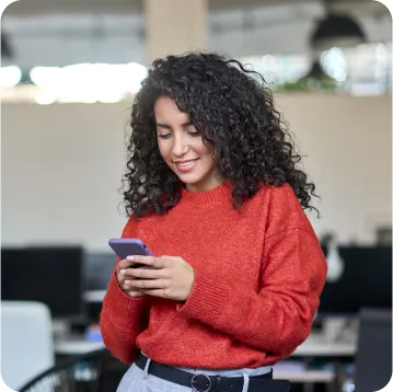 A girl looking at her phone with a smile