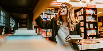 female college student at library getting books