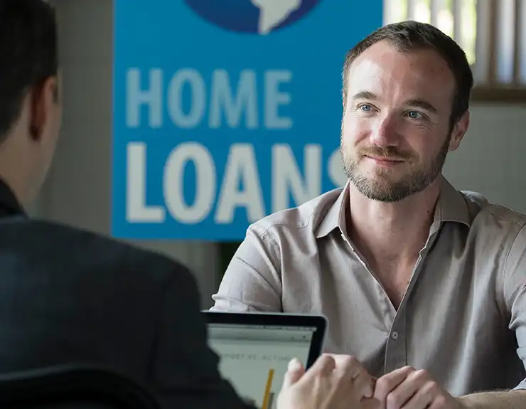 man in a credit union shopping for a home loan