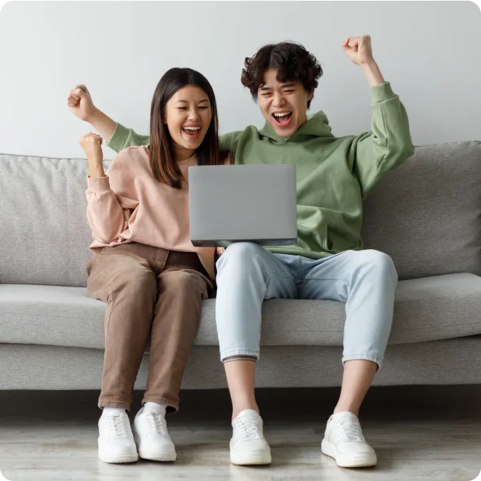 a couple reading some information on laptop