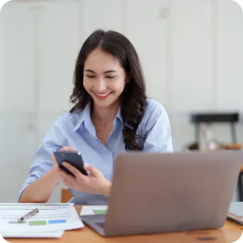 woman holding a phone in hand and smiling