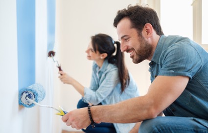 couple painting a room in their house