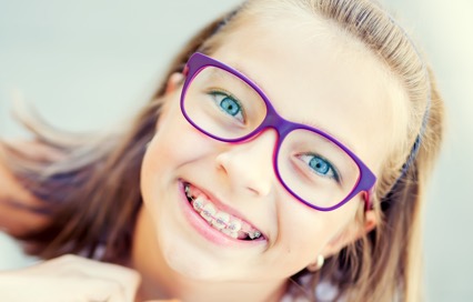 girl smiling with glasses and braces