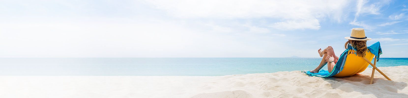 Woman sitting in front of a beachfront view.