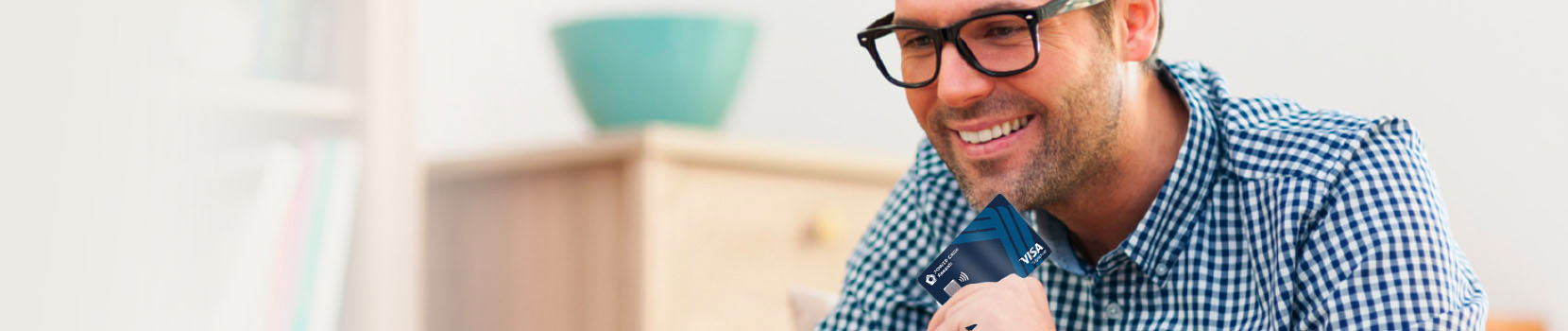 Man smiling while hold a PenFed Power Cash Credit