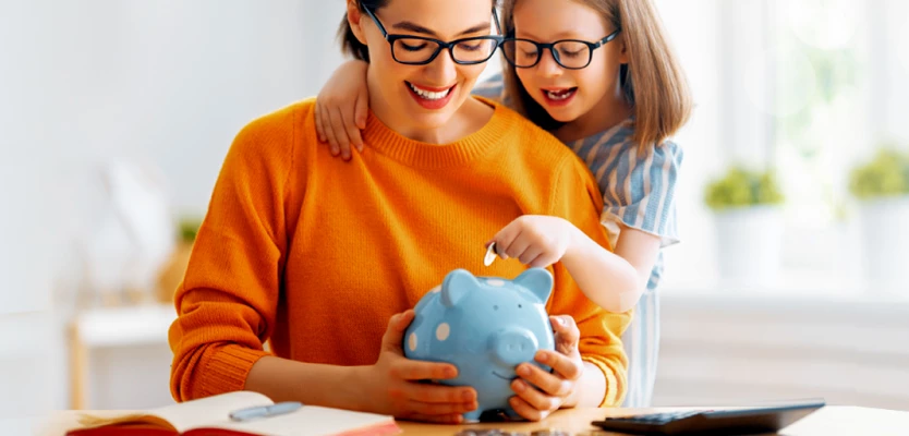 mother and daughter with piggy bank