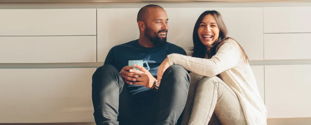 smiling couple sitting on the floor