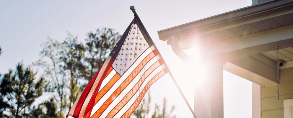 American flag flowing outside a house