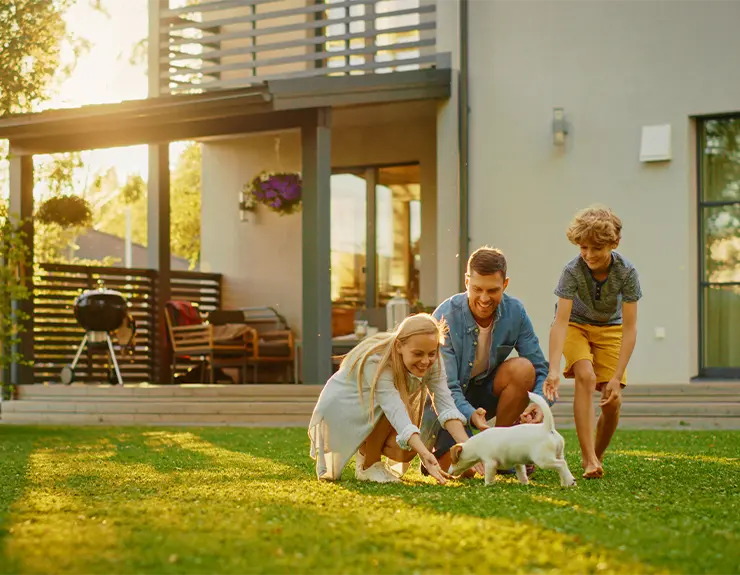 family in front of their house in summer