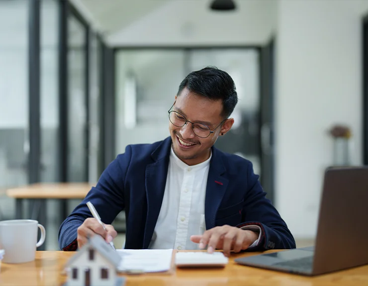 man signing home closing documents