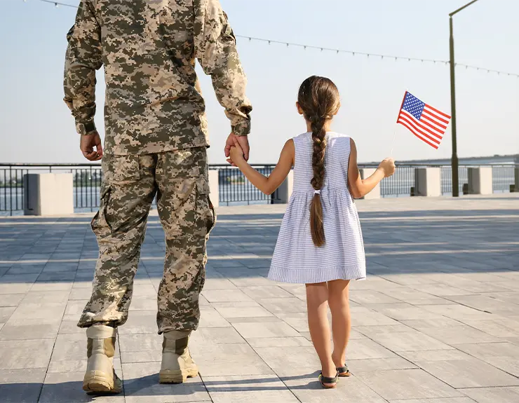 military father holding hands with daughter