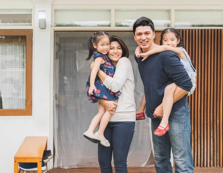 family in front of home