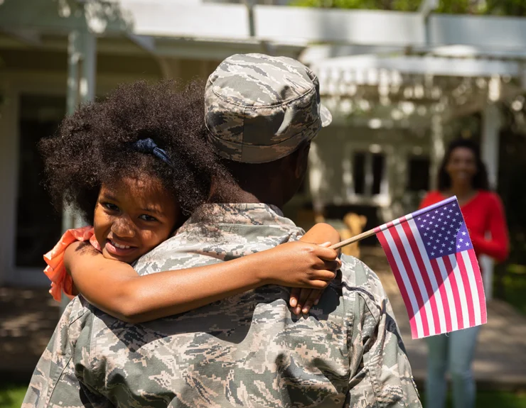 military mother hugging her daughter
