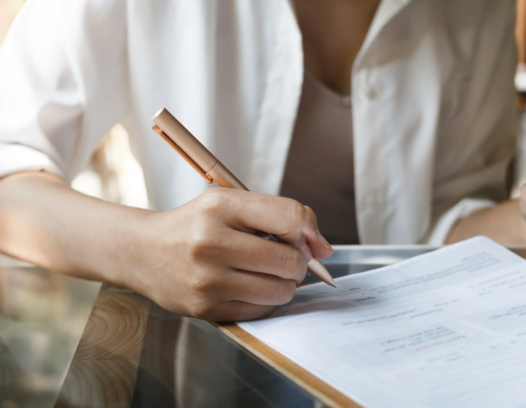 woman signing paperwork