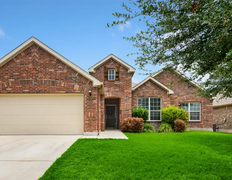 brick home with green grass