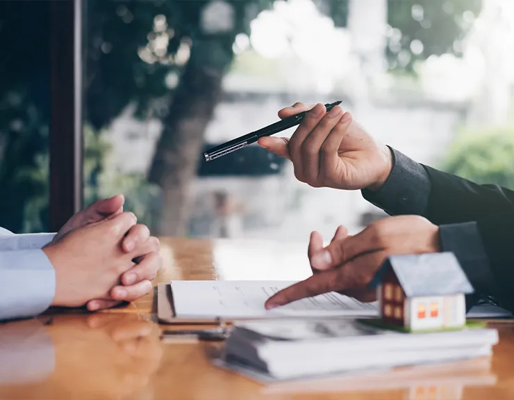 person being given a pen to sign a document