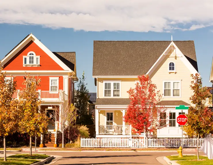 Image of single family home with white picket fence