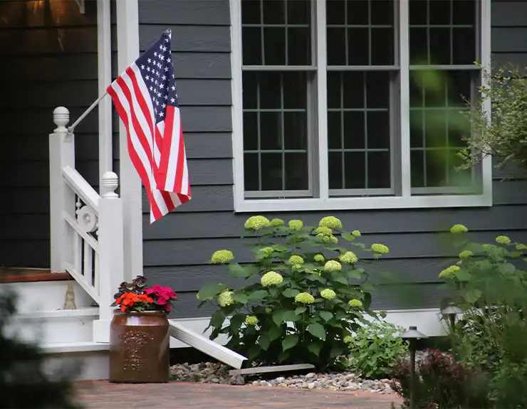 front porch of home with american flag waving