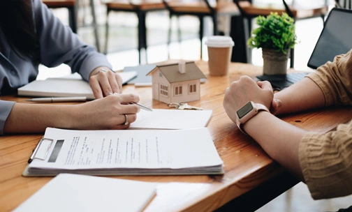 Real estate agent or bank officer describes the loan interest to the customer with home purchase contracts or on office loans and interest rates