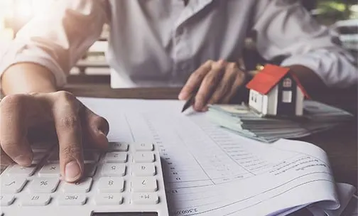 Customers use pens and calculators to calculate home purchase loans according to loan documents received from the bank. real estate concept.