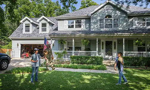 military servicemember throwing a ball with their kids