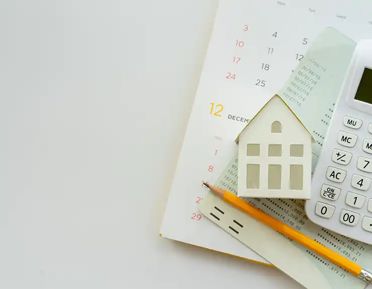 wooden home next to calculator